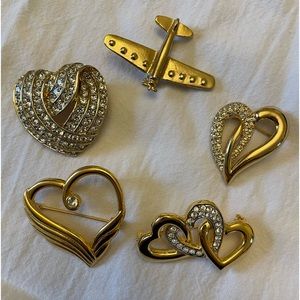 Four heart brooches and the cutest jet airplane.